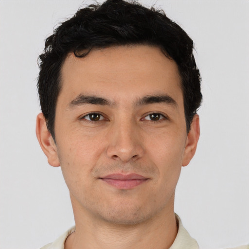 Joyful latino young-adult male with short  brown hair and brown eyes