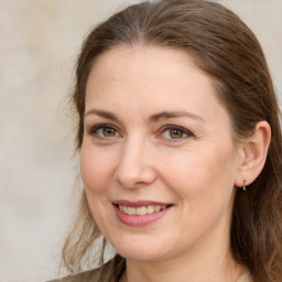 Joyful white adult female with medium  brown hair and grey eyes