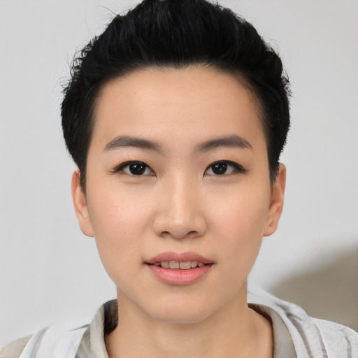 Joyful asian young-adult female with short  brown hair and brown eyes