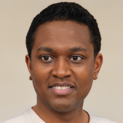 Joyful black young-adult male with short  black hair and brown eyes