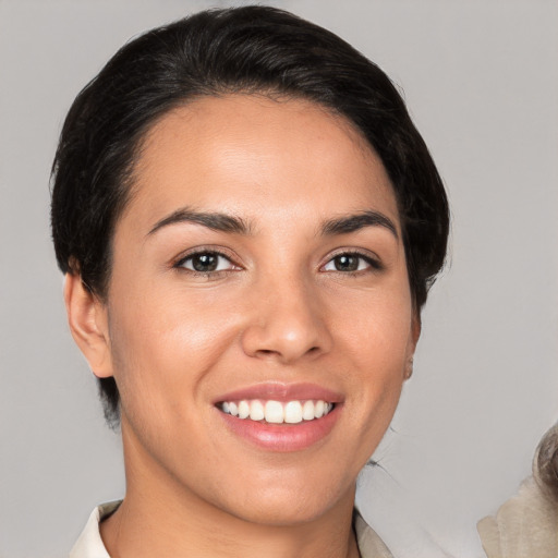 Joyful white young-adult female with short  brown hair and brown eyes