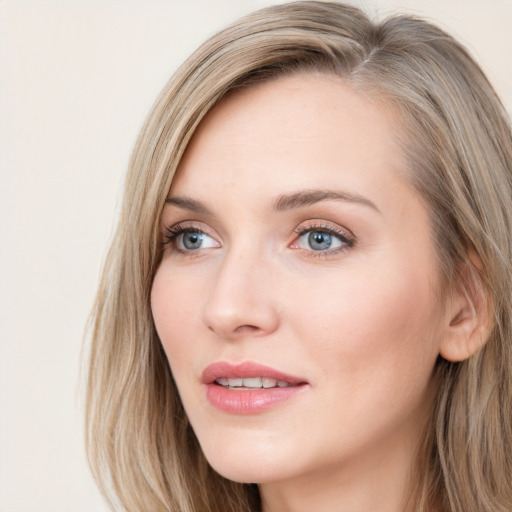 Joyful white young-adult female with long  brown hair and blue eyes