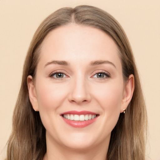 Joyful white young-adult female with long  brown hair and grey eyes