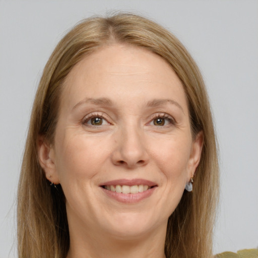 Joyful white adult female with long  brown hair and grey eyes