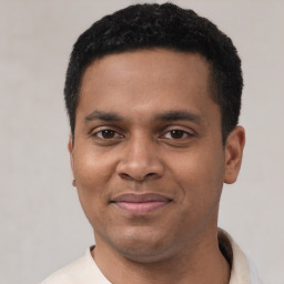 Joyful latino young-adult male with short  black hair and brown eyes