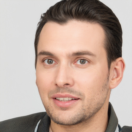 Joyful white young-adult male with short  brown hair and brown eyes