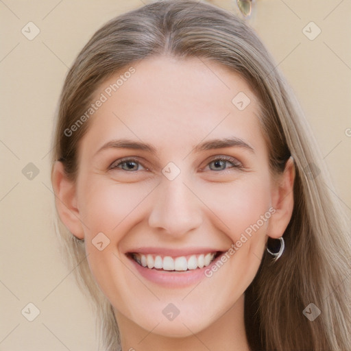 Joyful white young-adult female with long  brown hair and grey eyes