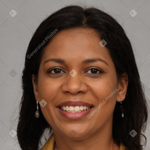 Joyful black adult female with long  brown hair and brown eyes