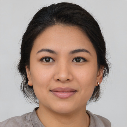 Joyful asian young-adult female with medium  brown hair and brown eyes