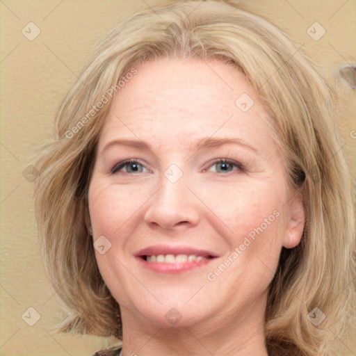 Joyful white adult female with medium  brown hair and blue eyes