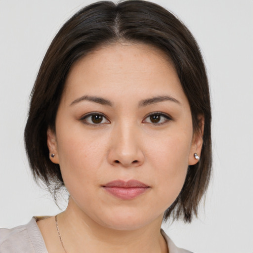 Joyful white young-adult female with medium  brown hair and brown eyes