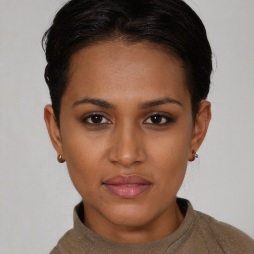 Joyful black young-adult female with short  brown hair and brown eyes