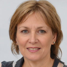 Joyful white adult female with medium  brown hair and grey eyes