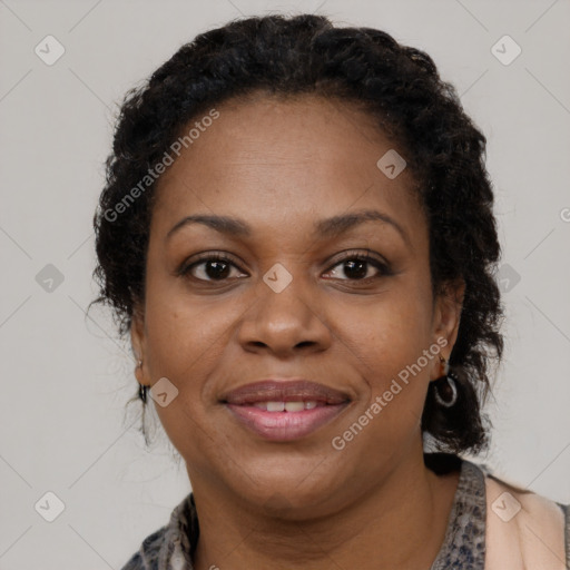 Joyful black adult female with long  brown hair and brown eyes