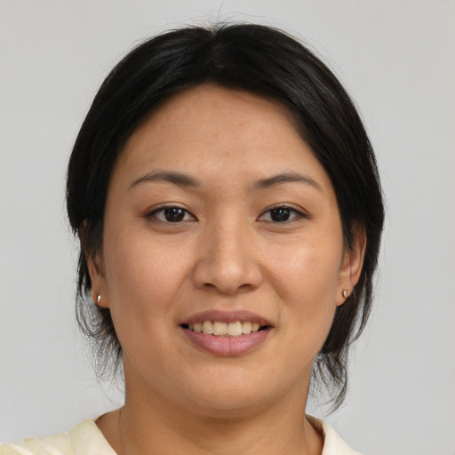 Joyful asian young-adult female with medium  brown hair and brown eyes
