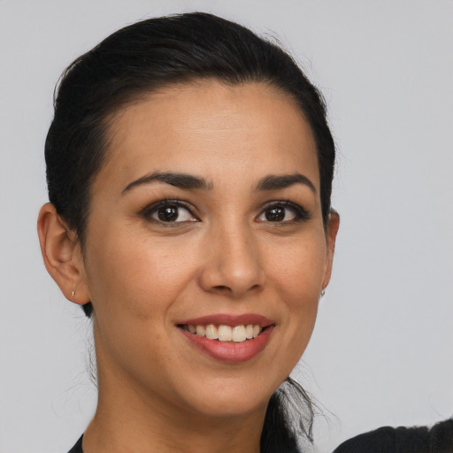 Joyful latino young-adult female with long  brown hair and brown eyes