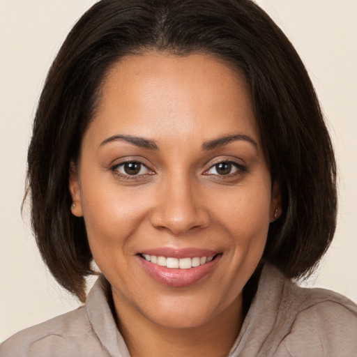 Joyful white young-adult female with medium  brown hair and brown eyes