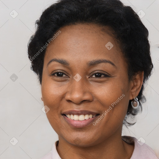 Joyful black adult female with short  brown hair and brown eyes