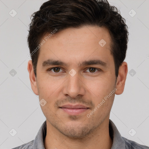 Joyful white young-adult male with short  brown hair and brown eyes