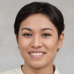 Joyful asian young-adult female with short  brown hair and brown eyes