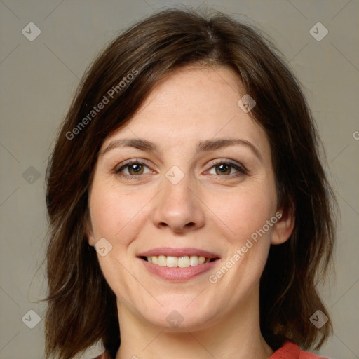 Joyful white young-adult female with medium  brown hair and green eyes