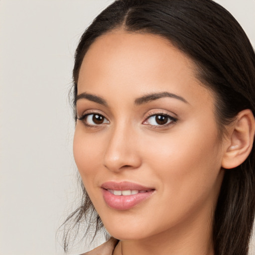 Joyful white young-adult female with long  brown hair and brown eyes