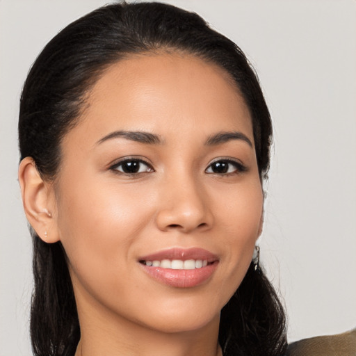 Joyful latino young-adult female with long  brown hair and brown eyes