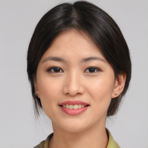 Joyful asian young-adult female with medium  brown hair and brown eyes