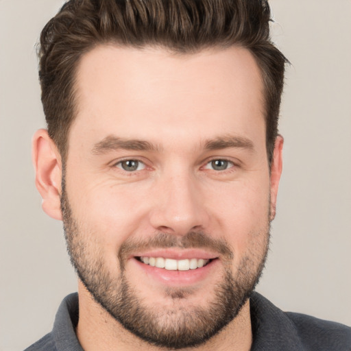 Joyful white young-adult male with short  brown hair and brown eyes