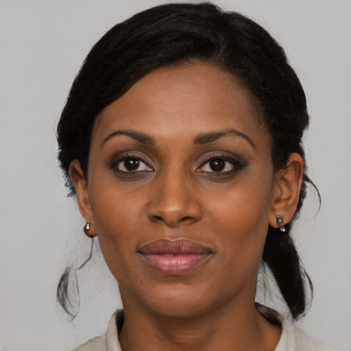 Joyful black young-adult female with medium  black hair and brown eyes