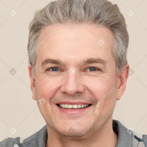 Joyful white adult male with short  brown hair and grey eyes