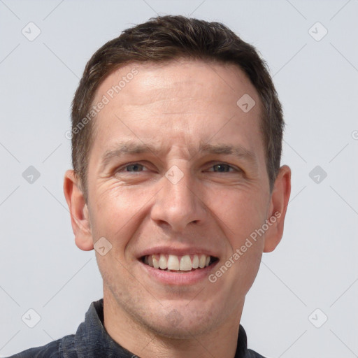 Joyful white adult male with short  brown hair and brown eyes