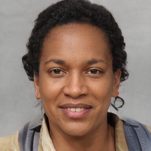 Joyful black adult female with short  brown hair and brown eyes