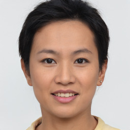 Joyful asian young-adult female with short  brown hair and brown eyes