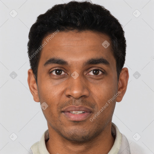 Joyful black young-adult male with short  black hair and brown eyes
