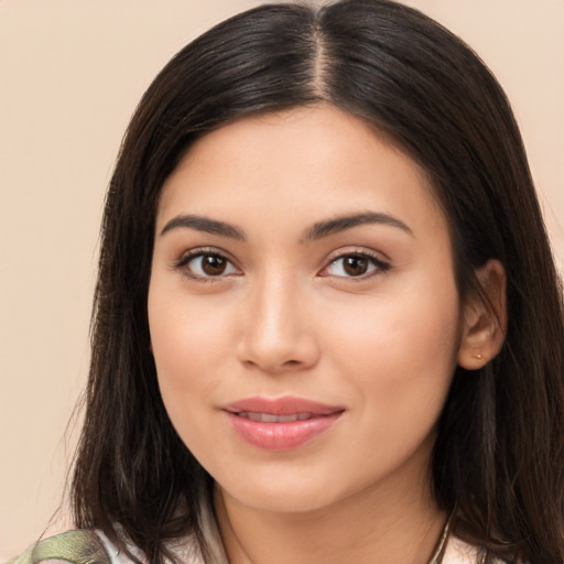 Joyful latino young-adult female with long  brown hair and brown eyes