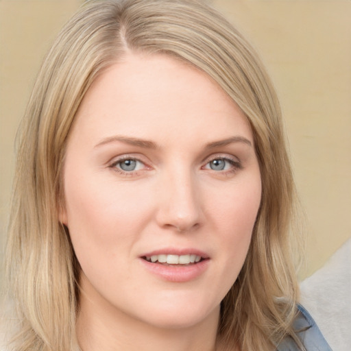 Joyful white young-adult female with long  brown hair and blue eyes