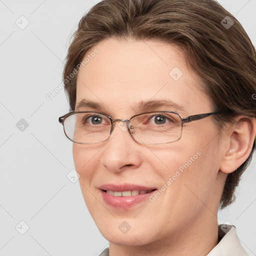 Joyful white adult female with medium  brown hair and grey eyes