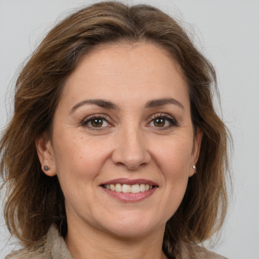 Joyful white adult female with medium  brown hair and brown eyes