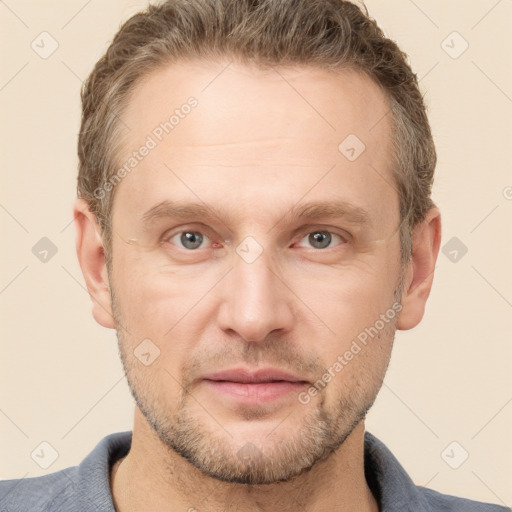 Joyful white adult male with short  brown hair and grey eyes