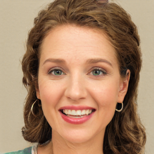 Joyful white young-adult female with long  brown hair and green eyes