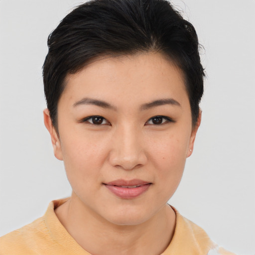 Joyful asian young-adult female with short  black hair and brown eyes