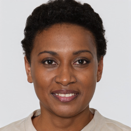 Joyful black young-adult female with short  brown hair and brown eyes