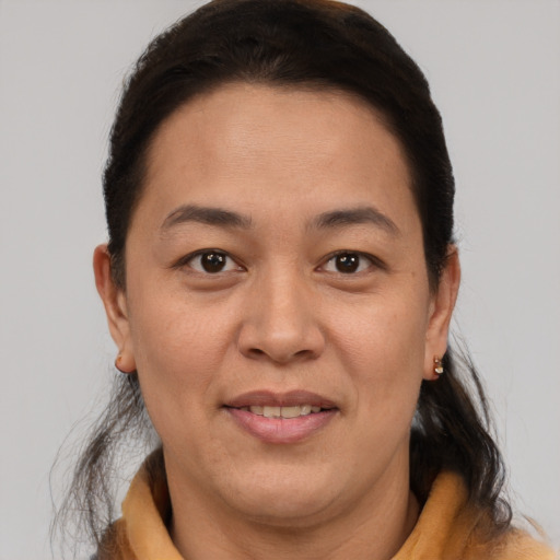 Joyful latino adult female with short  brown hair and brown eyes