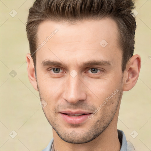 Joyful white young-adult male with short  brown hair and brown eyes