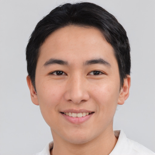 Joyful asian young-adult male with short  black hair and brown eyes