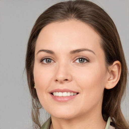 Joyful white young-adult female with medium  brown hair and brown eyes