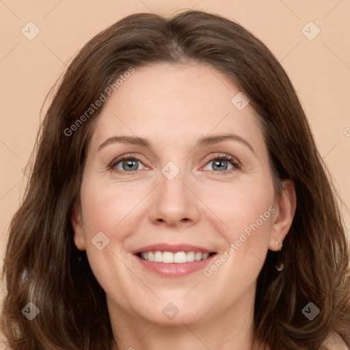 Joyful white adult female with long  brown hair and green eyes