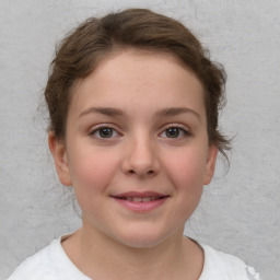 Joyful white child female with short  brown hair and brown eyes