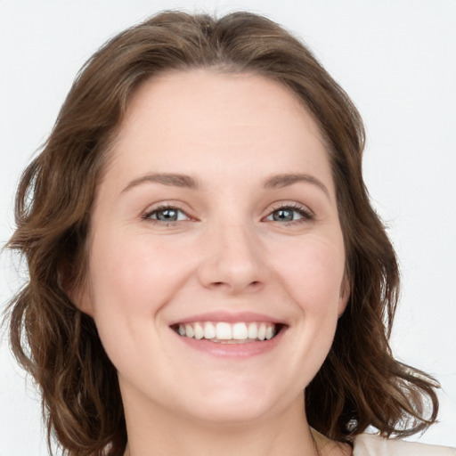 Joyful white young-adult female with long  brown hair and green eyes